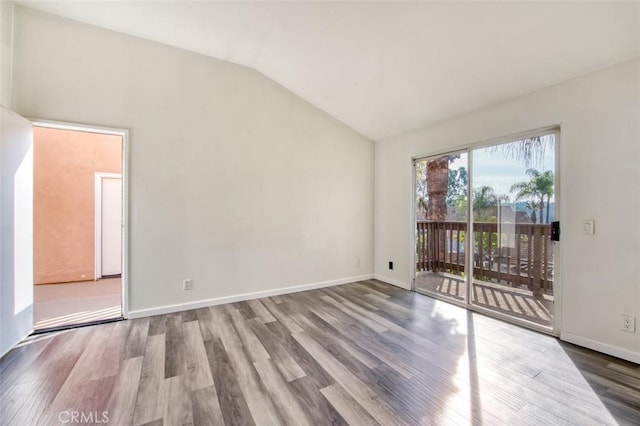 unfurnished room featuring lofted ceiling and wood-type flooring