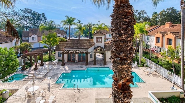 view of swimming pool featuring a pergola and a patio