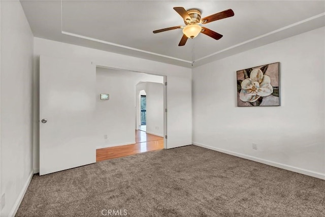 carpeted spare room with ceiling fan