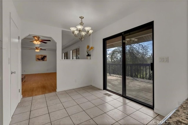 unfurnished room featuring ceiling fan with notable chandelier and light tile patterned floors