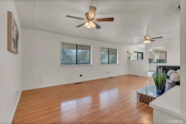 living room featuring ceiling fan and light hardwood / wood-style floors