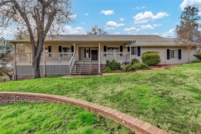 ranch-style home with a front lawn and a porch