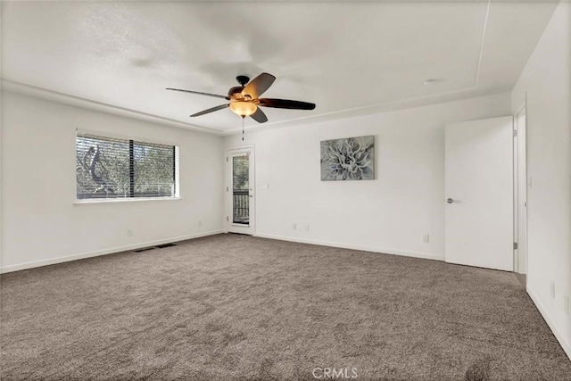 carpeted spare room featuring ceiling fan