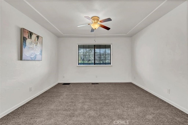 spare room featuring ceiling fan and carpet