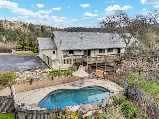 view of pool featuring a wooden deck and a patio area