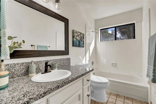 full bathroom featuring vanity, tiled shower / bath combo, tile patterned floors, and toilet