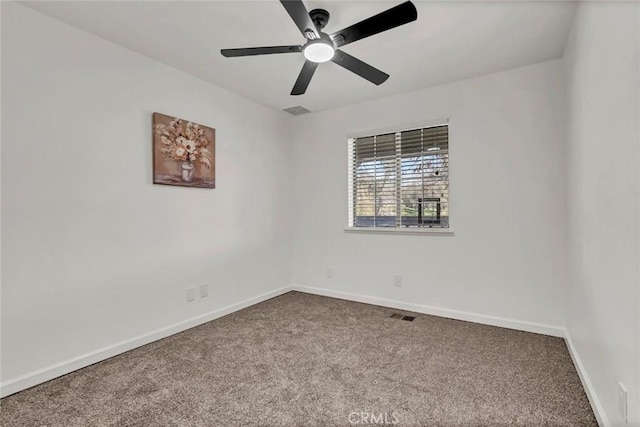 empty room with ceiling fan and carpet