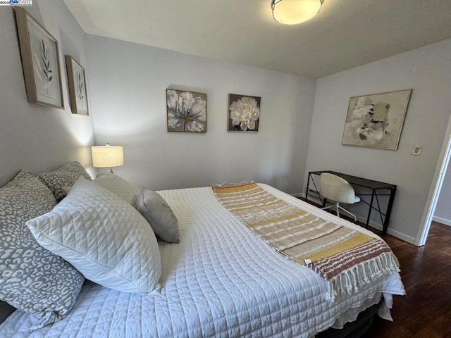 bedroom with dark hardwood / wood-style floors