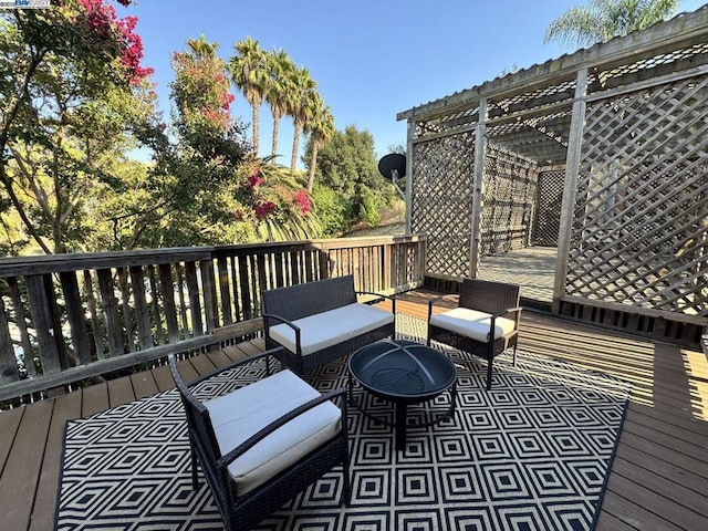 wooden terrace featuring outdoor lounge area and a pergola