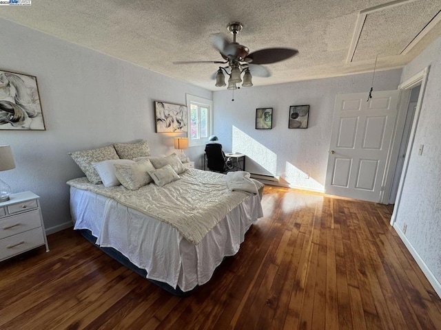 bedroom featuring ceiling fan, a textured ceiling, and dark hardwood / wood-style flooring