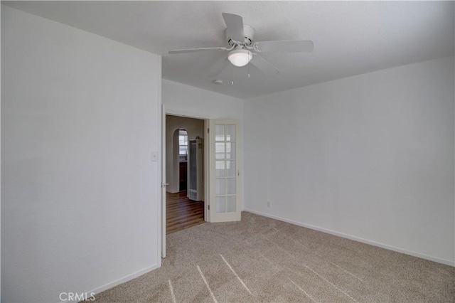 unfurnished room featuring light carpet and ceiling fan