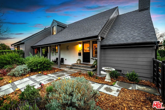 view of back house at dusk