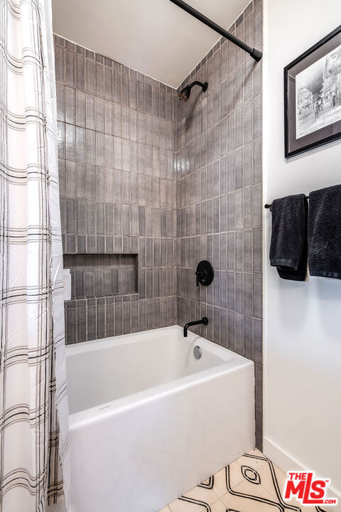 bathroom featuring tile patterned floors and shower / tub combo