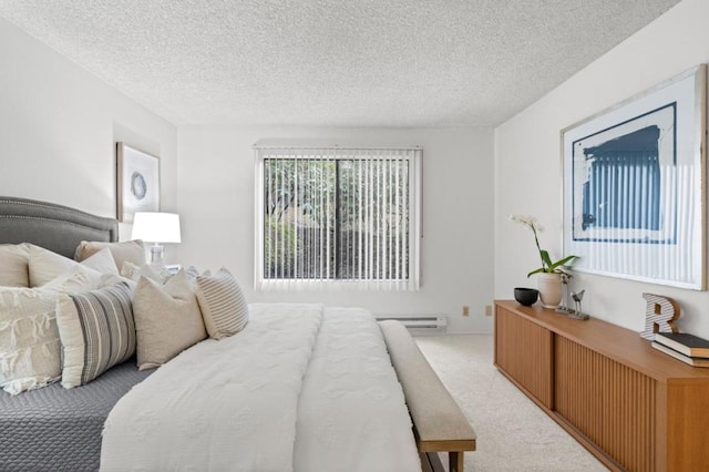 carpeted bedroom with baseboard heating and a textured ceiling