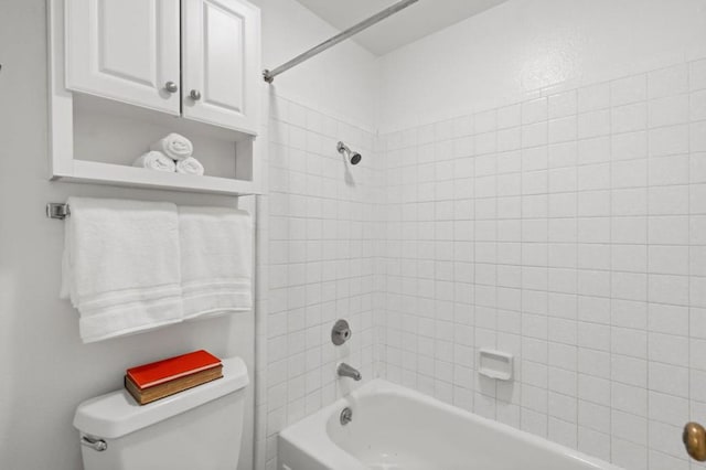 bathroom featuring toilet and tiled shower / bath combo