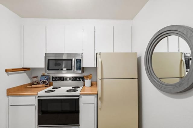 kitchen with white appliances and white cabinets