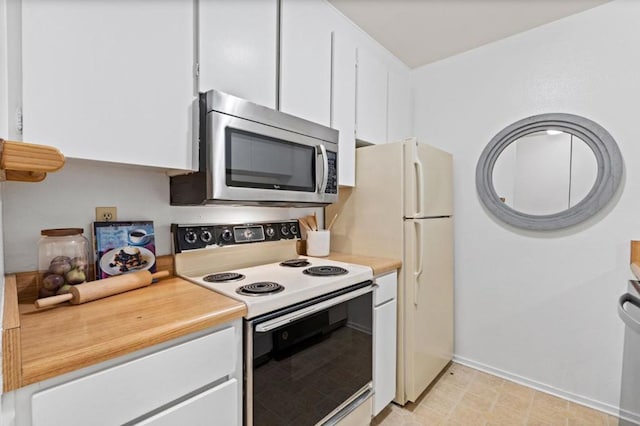 kitchen featuring white cabinetry and white range with electric stovetop