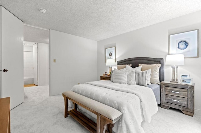 carpeted bedroom featuring a textured ceiling