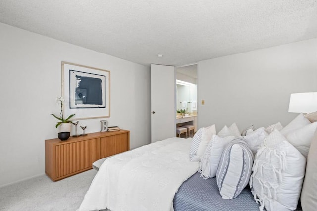 carpeted bedroom featuring a textured ceiling