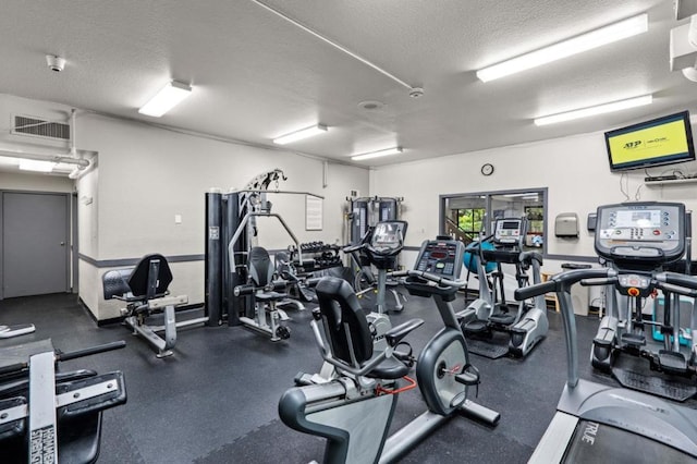 workout area with a textured ceiling