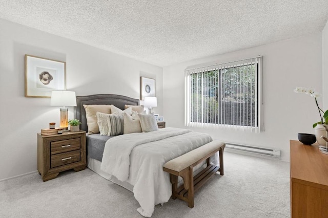 carpeted bedroom with a baseboard heating unit and a textured ceiling