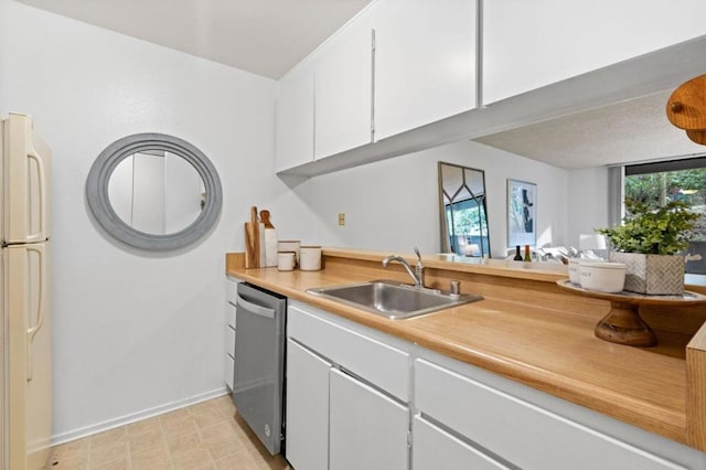 kitchen with white refrigerator, sink, stainless steel dishwasher, and white cabinets