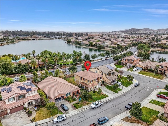 drone / aerial view featuring a water view and a residential view