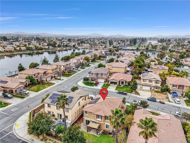 drone / aerial view with a water and mountain view and a residential view