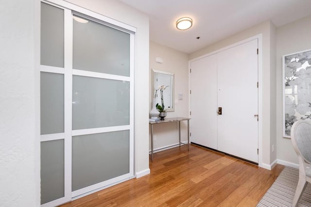 foyer entrance with light hardwood / wood-style floors