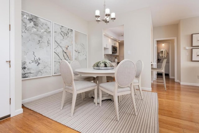 dining area featuring a chandelier and light hardwood / wood-style floors