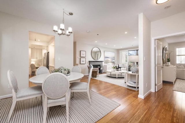 dining room with an inviting chandelier and hardwood / wood-style floors