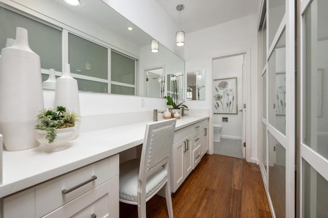 bathroom featuring vanity, toilet, and hardwood / wood-style floors