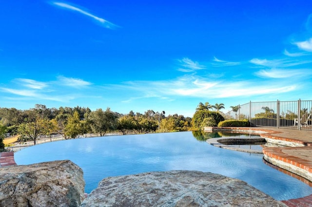 view of swimming pool featuring a water view