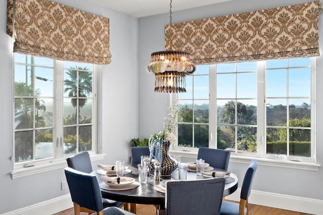 dining area featuring an inviting chandelier, plenty of natural light, and hardwood / wood-style floors