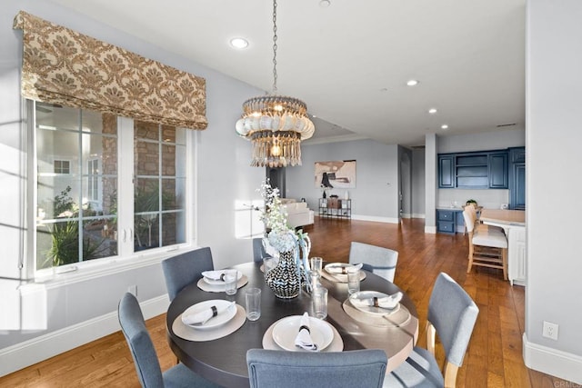 dining area featuring dark hardwood / wood-style flooring and an inviting chandelier