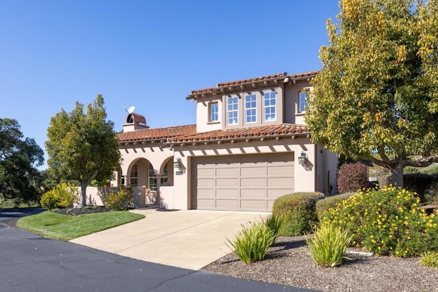 mediterranean / spanish-style house with a garage