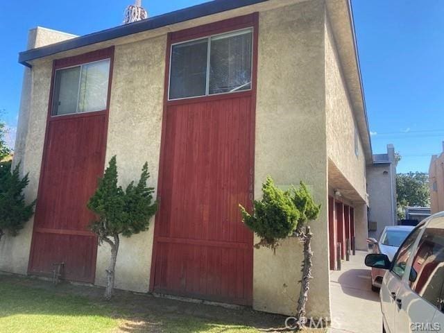 view of side of property with a garage and a lawn