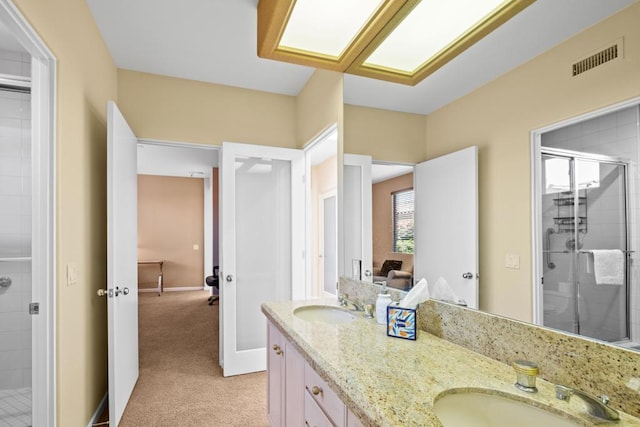 bathroom with an enclosed shower and vanity