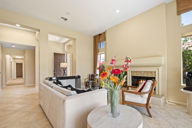 living room featuring light tile patterned floors and a premium fireplace