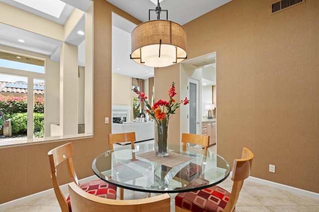 tiled dining area with a skylight