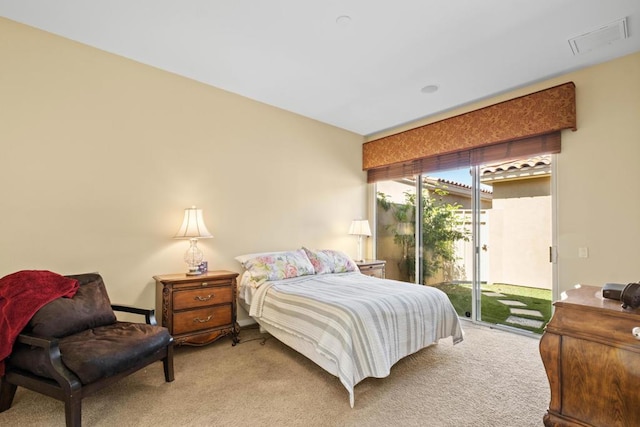 bedroom featuring access to exterior and light colored carpet