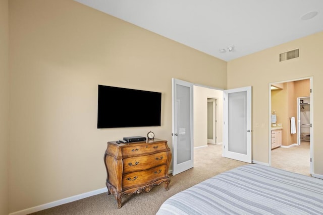 bedroom with french doors and light carpet