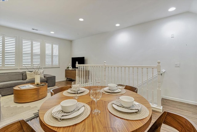 dining space featuring wood-type flooring