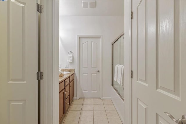 bathroom with vanity, tile patterned floors, and shower / bath combination with glass door