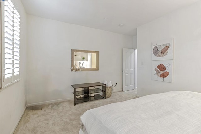 bedroom featuring light carpet