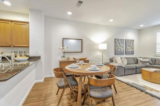 dining space with light hardwood / wood-style floors