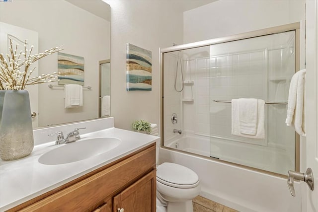 full bathroom with bath / shower combo with glass door, vanity, and toilet