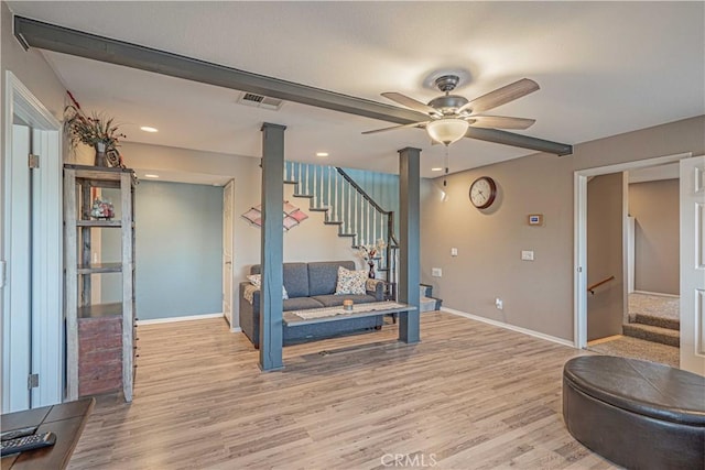 living room with ceiling fan and light wood-type flooring