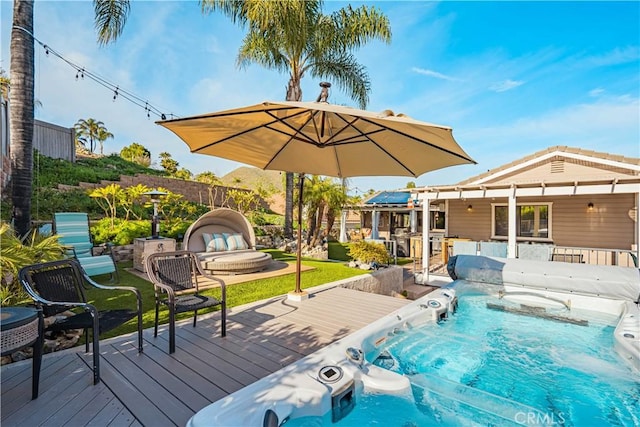 view of pool featuring a wooden deck and a lawn