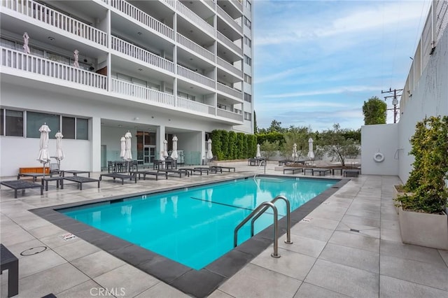 view of swimming pool with a patio